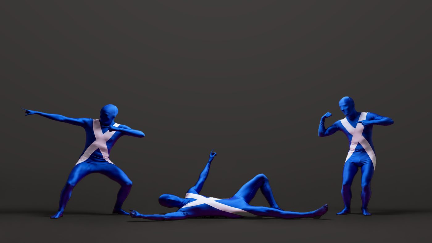 Three Saltire-print Morphsuits on a charcoal studio backdrop